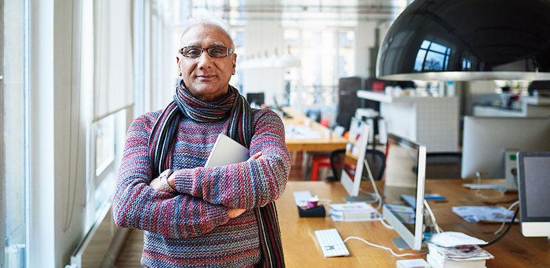 Older gentleman standing in office space