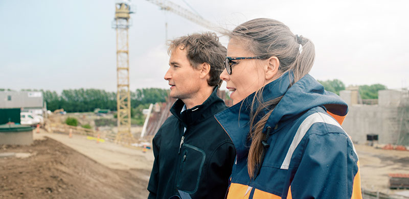 Man and woman talking on construction site