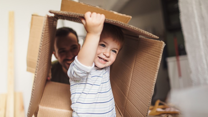 Toddler playing with cardboard box Toddler playing with cardboard box