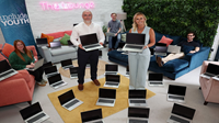 Danske Bank donates 50 laptops to charity partner Include Youth Six people pictured in Include Youth headquarters with lots of open laptops surrounding them!